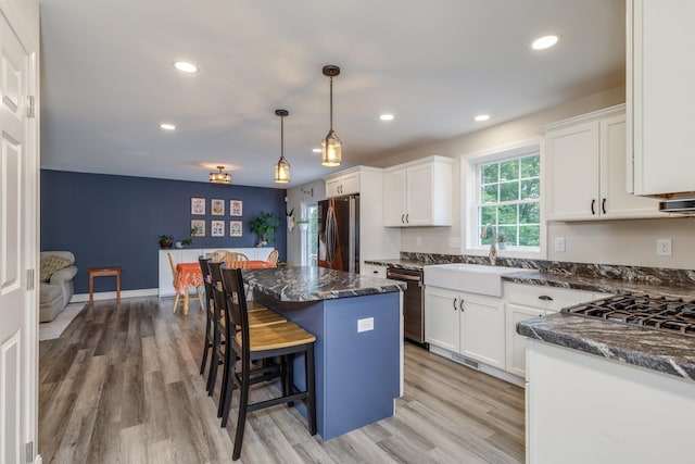 5 Turnpike St, Pembroke, NH 03275 - kitchen with stainless steel refrigerator with ice dispenser, a kitchen breakfast bar, a kitchen island, white cabinetry, and dishwashing machine