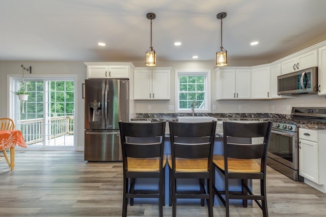 5 Turnpike St, Pembroke, NH 03275 - kitchen with stainless steel appliances, white cabinets, light wood-style flooring, hanging light fixtures, and recessed lighting