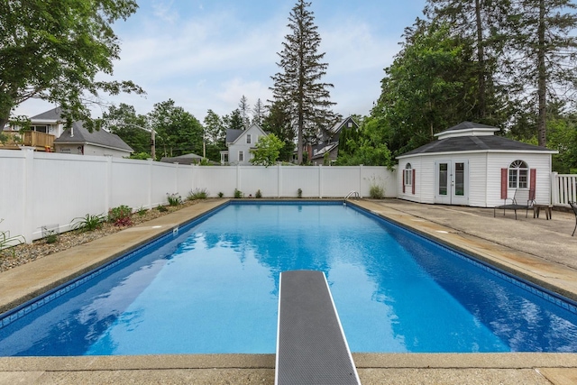 5 Turnpike St, Pembroke, NH 03275 - view of pool featuring a fenced backyard, a patio area, french doors, a diving board, and an outbuilding