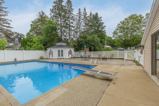 5 Turnpike St, Pembroke, NH 03275 - view of swimming pool with a patio area, a fenced backyard, french doors, a diving board, and an outbuilding