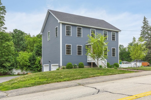 5 Turnpike St, Pembroke, NH 03275 - colonial house featuring a front lawn, a garage, and roof with shingles