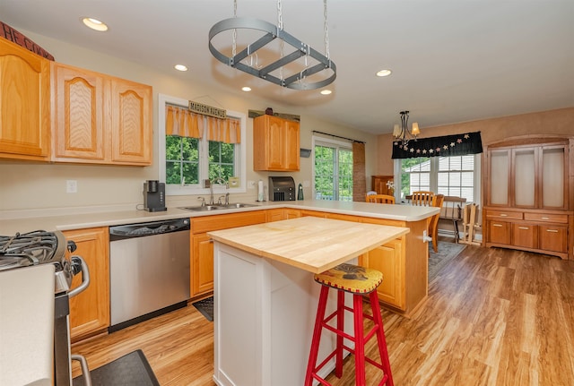 20 Brenda Ln, Rochester, NH 03867 - kitchen featuring stainless steel appliances, a chandelier, a peninsula, a kitchen breakfast bar, and light wood-style floors