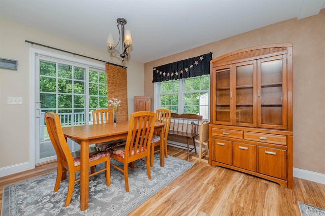 20 Brenda Ln, Rochester, NH 03867 - dining room with light wood-style floors, a chandelier, and a baseboard heating unit