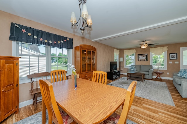 20 Brenda Ln, Rochester, NH 03867 - dining space with light wood-style floors, a chandelier, a ceiling fan, and beamed ceiling