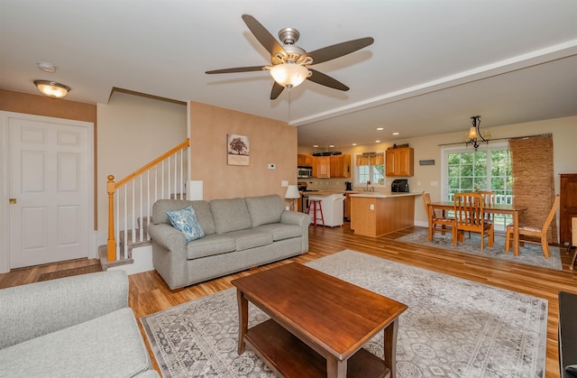 20 Brenda Ln, Rochester, NH 03867 - living area with a ceiling fan, light wood-style flooring, and stairs