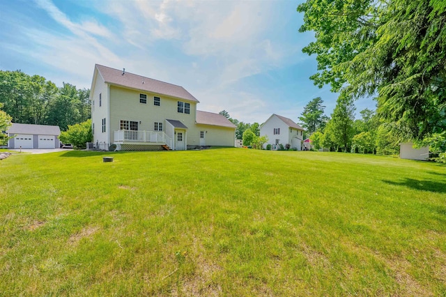 20 Brenda Ln, Rochester, NH 03867 - rear view of house featuring a lawn, a deck, and a detached garage