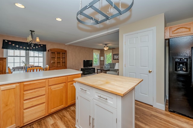 20 Brenda Ln, Rochester, NH 03867 - kitchen with black fridge, a chandelier, light wood-style flooring, butcher block countertops, and ceiling fan