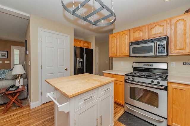 20 Brenda Ln, Rochester, NH 03867 - kitchen featuring appliances with stainless steel finishes, butcher block countertops, light wood-type flooring, a center island, and light brown cabinetry