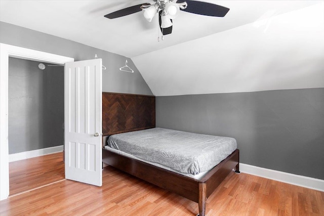 226 N St, Bennington, VT 05201 - bedroom featuring vaulted ceiling, wood finished floors, and a ceiling fan