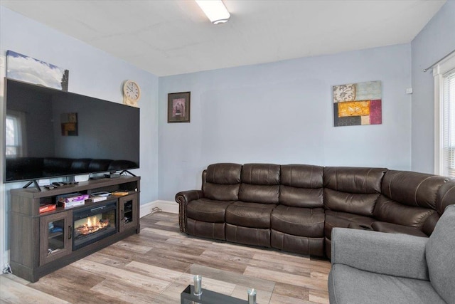 226 N St, Bennington, VT 05201 - living area featuring wood finished floors and a glass covered fireplace