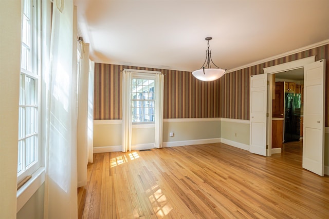 4 Spaulding St, Concord, NH 03301 - empty room featuring wallpapered walls, light wood finished floors, and ornamental molding