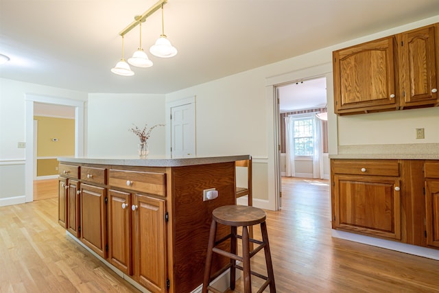 4 Spaulding St, Concord, NH 03301 - kitchen featuring brown cabinets, light wood-style flooring, and light countertops