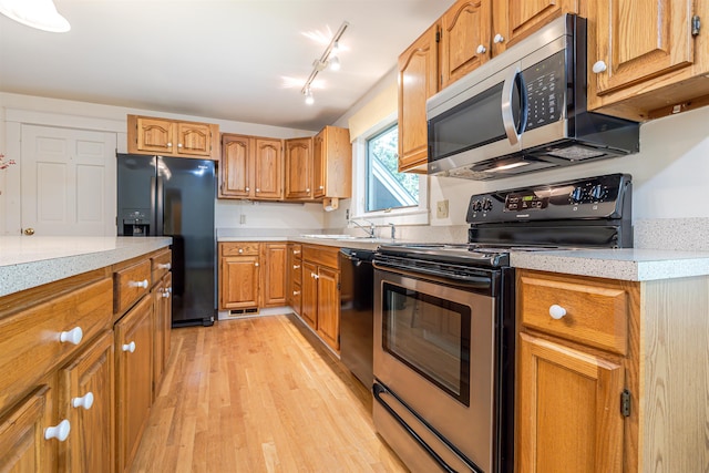 4 Spaulding St, Concord, NH 03301 - kitchen with appliances with stainless steel finishes, light wood-style flooring, and brown cabinets