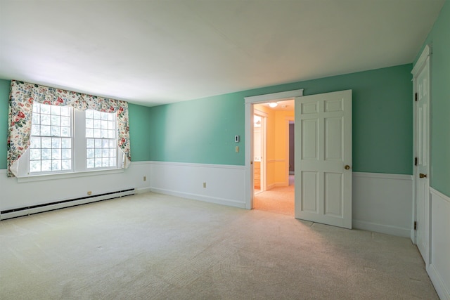 4 Spaulding St, Concord, NH 03301 - carpeted empty room featuring a baseboard radiator and a wainscoted wall