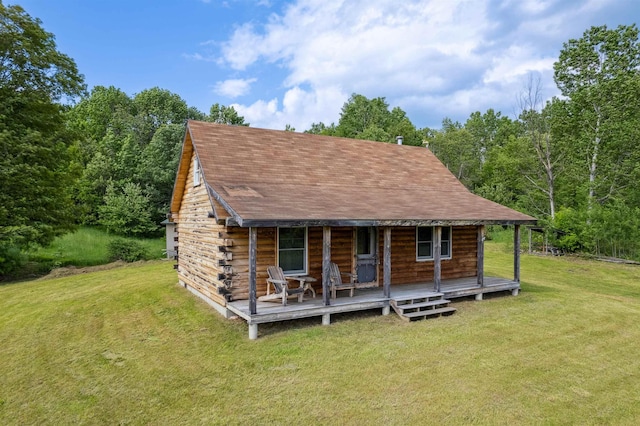 28 New Brighton Hill Rd, Tunbridge, VT 05077 - view of front of house with a front lawn, roof with shingles, a porch, log exterior, and a wooded view