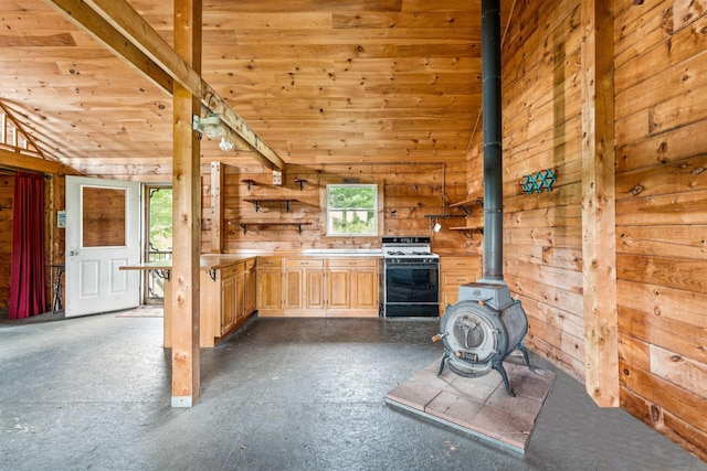 28 New Brighton Hill Rd, Tunbridge, VT 05077 - kitchen with gas range gas stove, a wood stove, open shelves, wood walls, and light brown cabinets