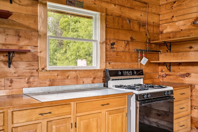 28 New Brighton Hill Rd, Tunbridge, VT 05077 - kitchen featuring range with gas cooktop, healthy amount of natural light, light countertops, and wood walls