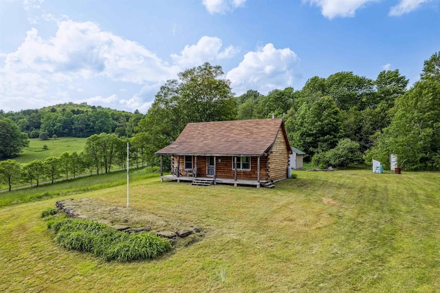28 New Brighton Hill Rd, Tunbridge, VT 05077 - view of front facade with a front lawn, log siding, a forest view, and covered porch