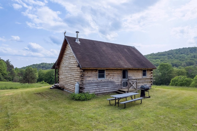 28 New Brighton Hill Rd, Tunbridge, VT 05077 - back of property featuring a barn, a yard, a wooded view, an outdoor structure, and roof with shingles