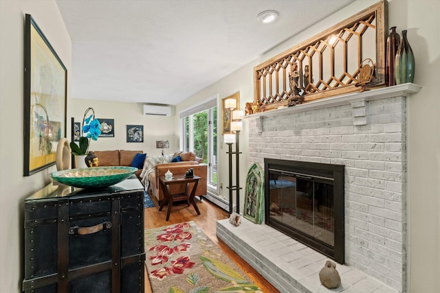 13 Judith Dr, Concord, NH 03301 - living area featuring an AC wall unit, a brick fireplace, wood finished floors, and a baseboard heating unit