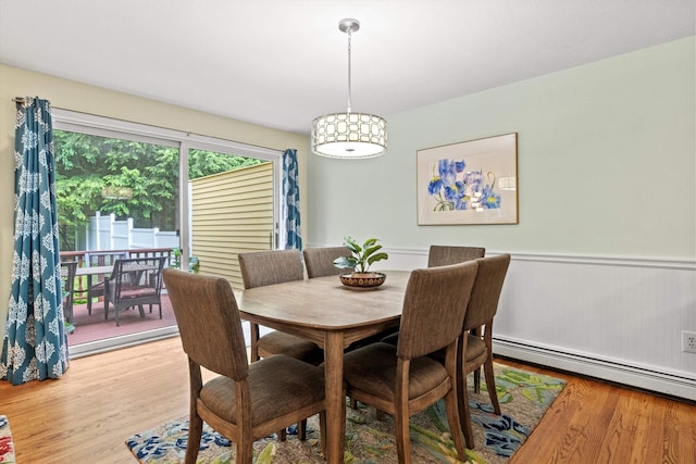 13 Judith Dr, Concord, NH 03301 - dining area with a baseboard radiator, light wood-style flooring, and wainscoting