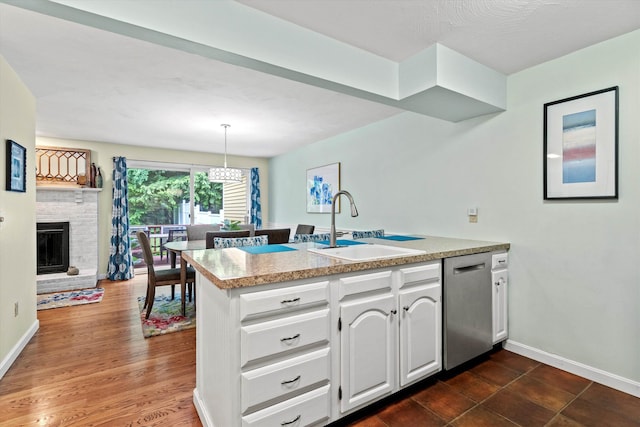 13 Judith Dr, Concord, NH 03301 - kitchen with stainless steel dishwasher, a peninsula, white cabinetry, light countertops, and a fireplace