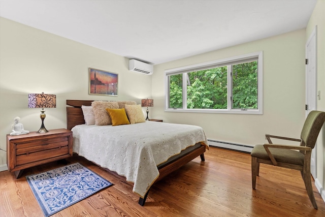 13 Judith Dr, Concord, NH 03301 - bedroom featuring a baseboard heating unit, a wall mounted AC, and wood finished floors