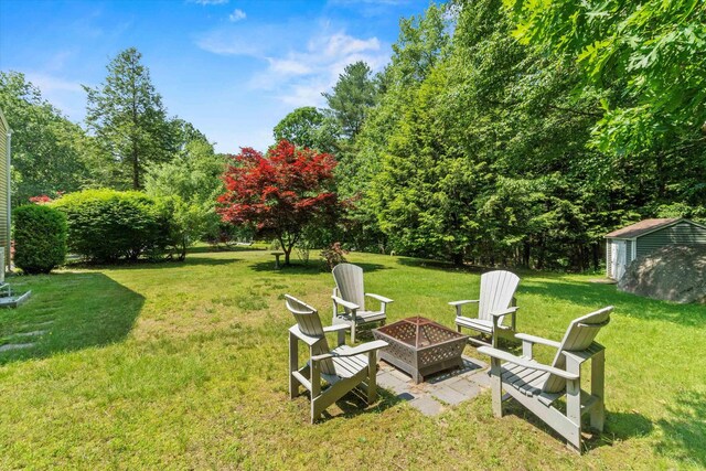 13 Judith Dr, Concord, NH 03301 - view of green lawn with an outdoor fire pit and a storage shed