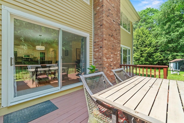 13 Judith Dr, Concord, NH 03301 - wooden deck with outdoor dining area and a storage unit