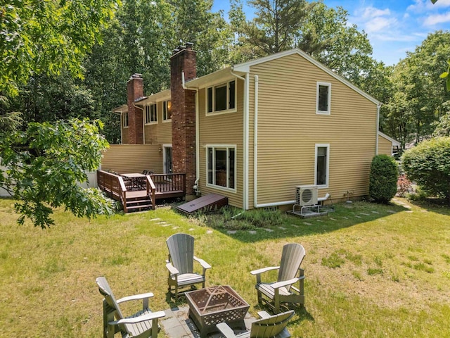 13 Judith Dr, Concord, NH 03301 - rear view of house featuring a fire pit, a wooden deck, a yard, and a chimney