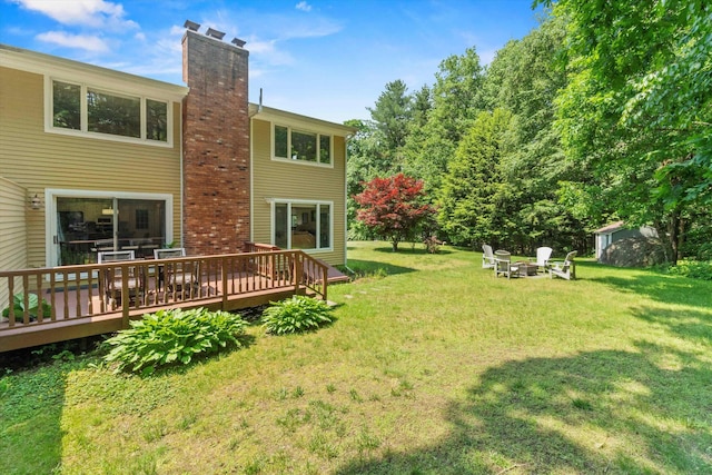 13 Judith Dr, Concord, NH 03301 - view of green lawn featuring a deck and a fire pit