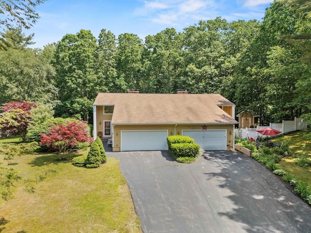 13 Judith Dr, Concord, NH 03301 - view of front of property with asphalt driveway, a chimney, and an attached garage