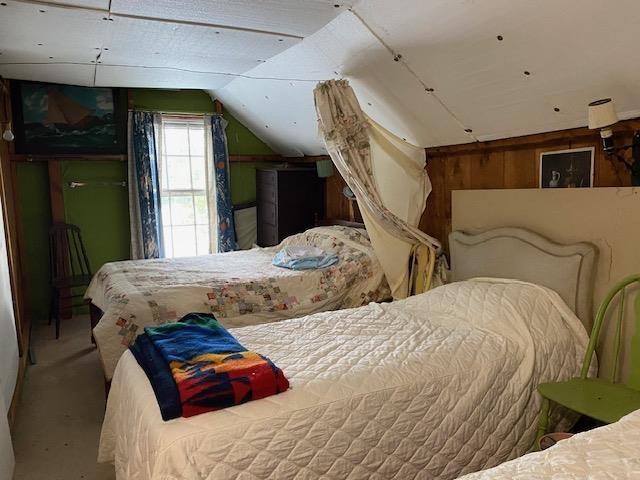 126 Crescent Lake Rd, Acworth, NH 03601 - bedroom featuring lofted ceiling, wooden walls, and carpet flooring