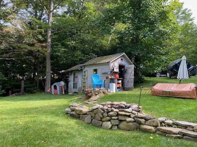 126 Crescent Lake Rd, Acworth, NH 03601 - view of grassy yard featuring a storage unit