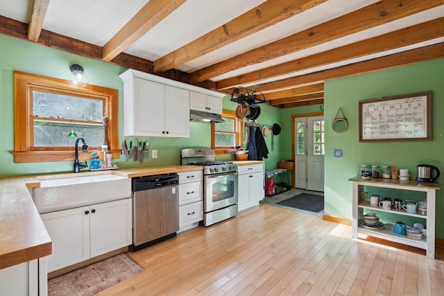 103 Potash Hill Rd, Tunbridge, VT 05077 - kitchen featuring appliances with stainless steel finishes, light countertops, under cabinet range hood, beam ceiling, and white cabinets