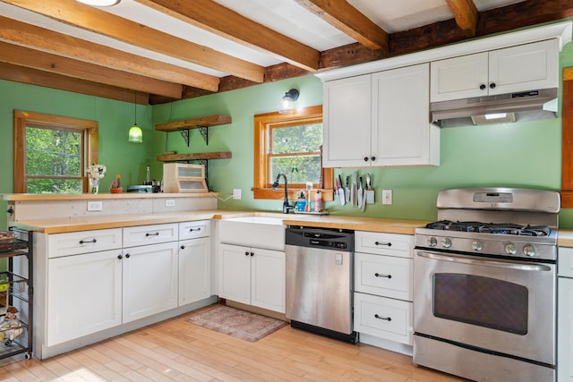 103 Potash Hill Rd, Tunbridge, VT 05077 - kitchen with stainless steel appliances, under cabinet range hood, beamed ceiling, a peninsula, and healthy amount of natural light