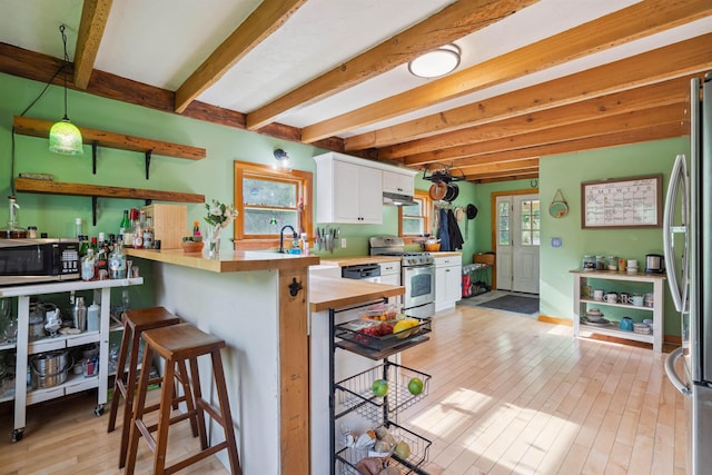 103 Potash Hill Rd, Tunbridge, VT 05077 - kitchen with stainless steel appliances, beamed ceiling, white cabinets, light wood-style flooring, and a peninsula