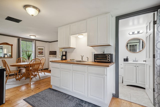 103 Potash Hill Rd, Tunbridge, VT 05077 - kitchen featuring white cabinets, light wood-style flooring, and wooden counters