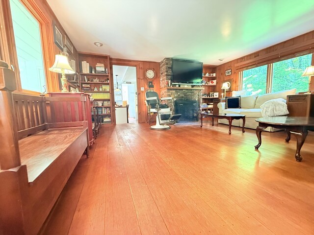 789 Hammond Hill Rd, West Windsor, VT 05089 - living room with wooden walls, wood finished floors, and a fireplace