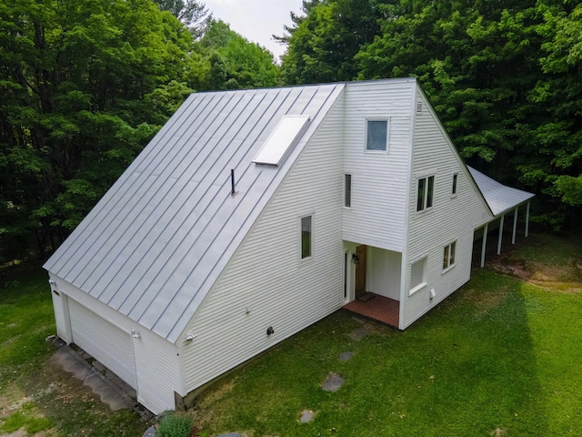 789 Hammond Hill Rd, West Windsor, VT 05089 - view of front facade with a front lawn, a metal roof, a garage, and a forest view
