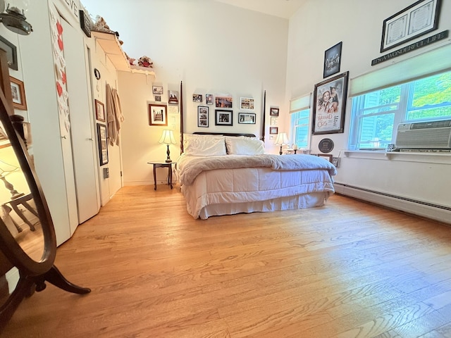 789 Hammond Hill Rd, West Windsor, VT 05089 - bedroom featuring light wood-type flooring, cooling unit, baseboard heating, and a high ceiling