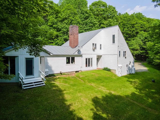 789 Hammond Hill Rd, West Windsor, VT 05089 - rear view of property with a lawn, a chimney, entry steps, and a view of trees