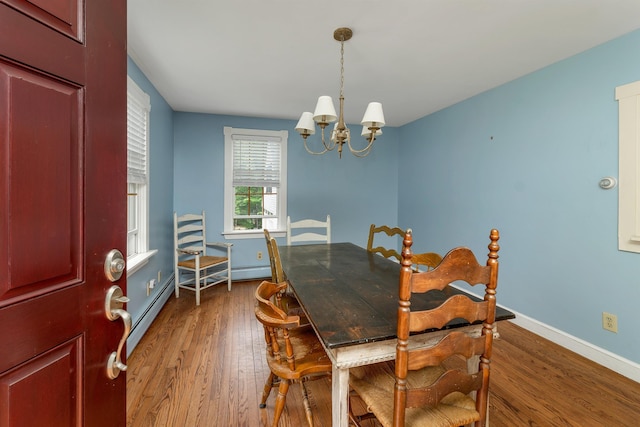 400 Turkey St, Tamworth, NH 03886 - dining area with wood finished floors, a chandelier, and a baseboard heating unit