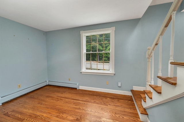400 Turkey St, Tamworth, NH 03886 - spare room with stairs, a baseboard radiator, and wood finished floors