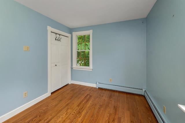 400 Turkey St, Tamworth, NH 03886 - unfurnished bedroom with a baseboard radiator and wood finished floors