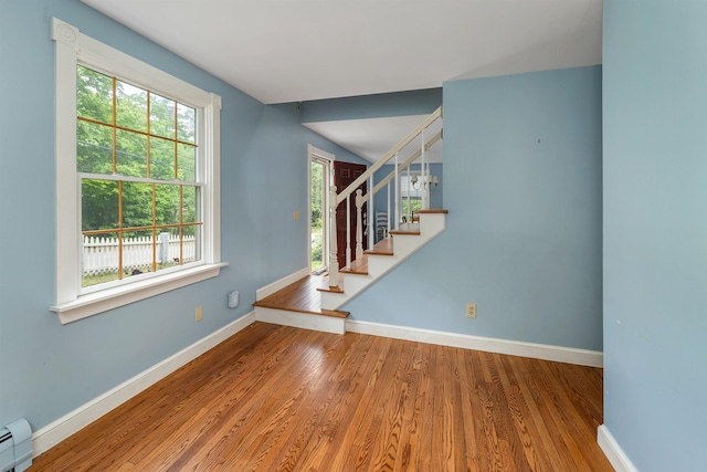 400 Turkey St, Tamworth, NH 03886 - entryway featuring a baseboard radiator, stairs, wood finished floors, and vaulted ceiling