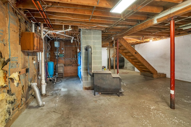 400 Turkey St, Tamworth, NH 03886 - unfinished below grade area featuring oil tank, a water pressure tank, and stairs