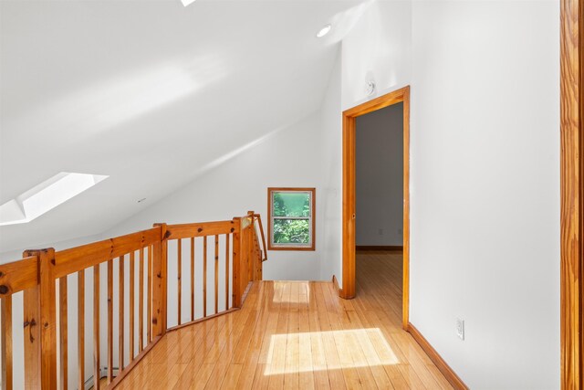 12 Cornwall Pl, Farmington, NH 03835 - corridor featuring a skylight, vaulted ceiling, and hardwood / wood-style flooring