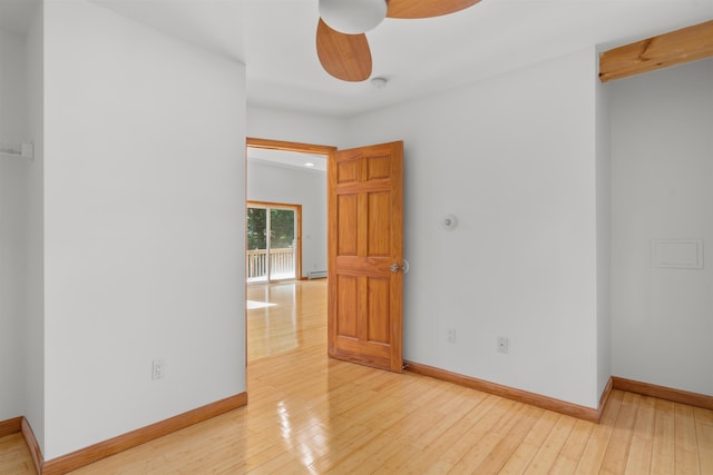 12 Cornwall Pl, Farmington, NH 03835 - empty room featuring ceiling fan, hardwood / wood-style flooring, a baseboard radiator, and a smoke detector