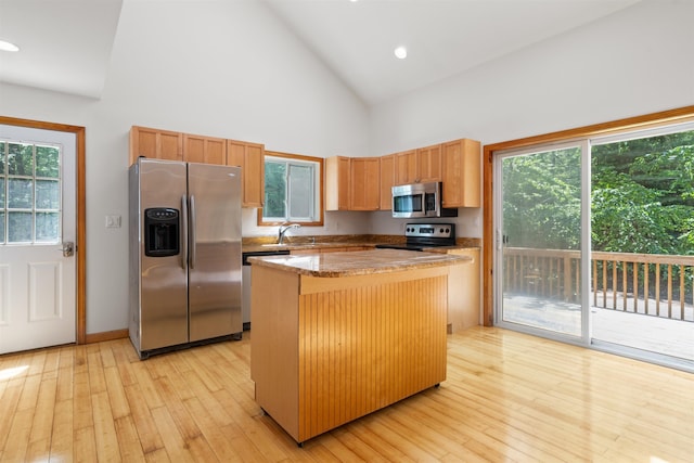 12 Cornwall Pl, Farmington, NH 03835 - kitchen with stainless steel appliances, high vaulted ceiling, a kitchen island, light wood finished floors, and recessed lighting